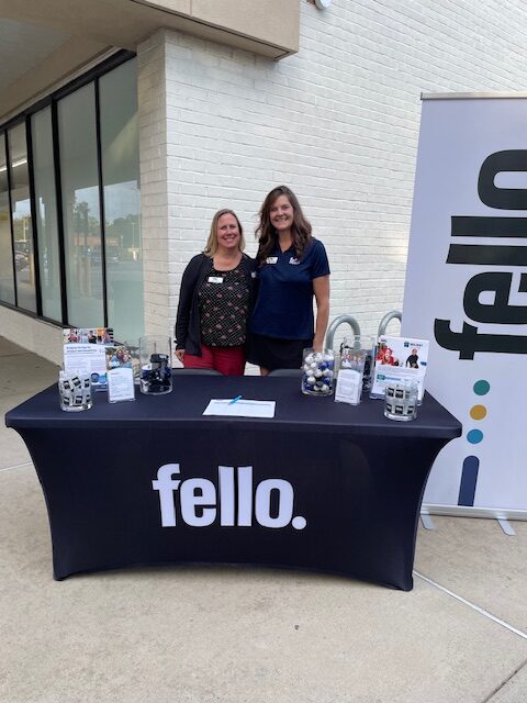 Representatives from Fello at a community event display table.
